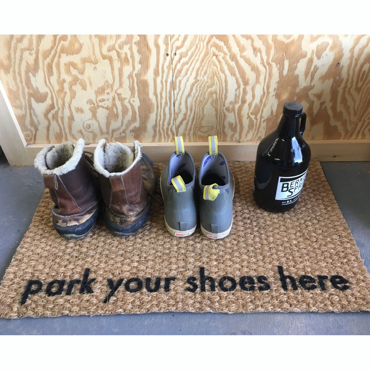 coir doormat reading park your shoes here with pairs of boots on it in garage